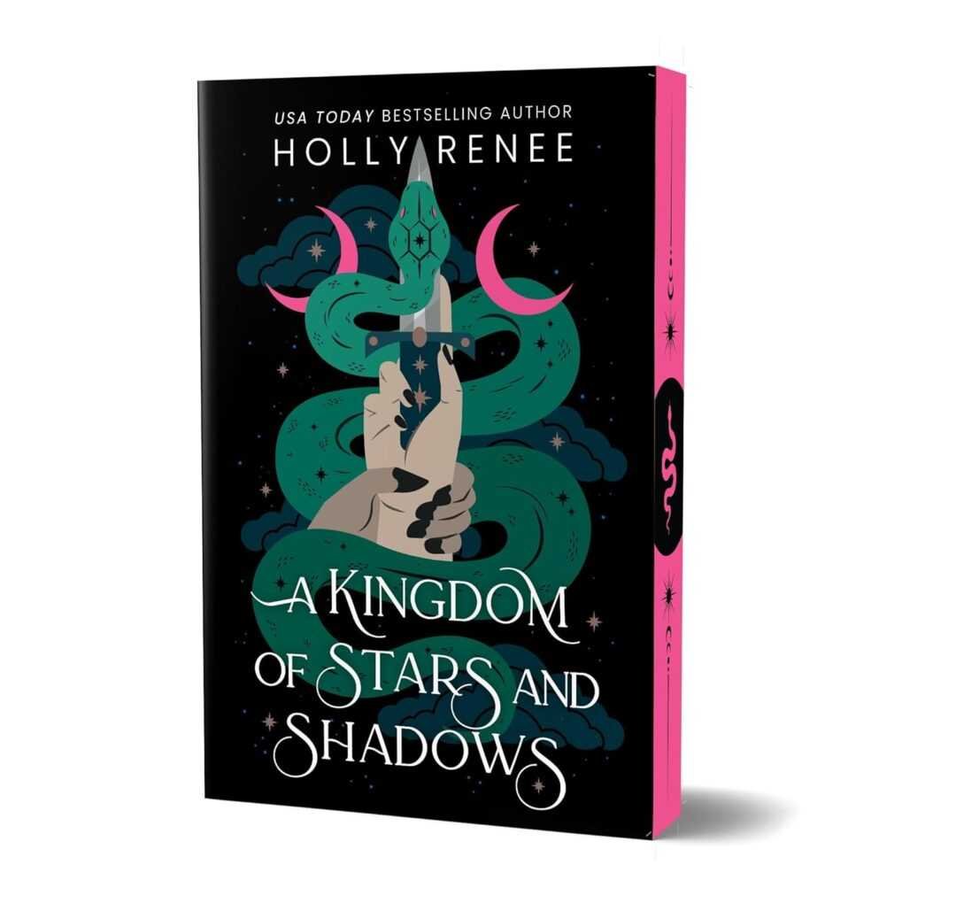 Deluxe edition book cover of A Kingdom of Stars and Shadows by Holly Renee features a hand gripping a dagger with a green snake, crescent moon, and stars on black plus bright pink page edges. Viral Book Recommendations.