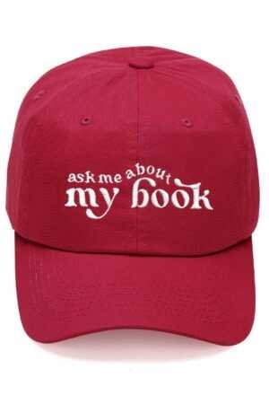 The Ask Me About My Book Cap is a red baseball cap embroidered with "ask me about my book" in white—ideal for fans of viral book recommendations and romance novels.