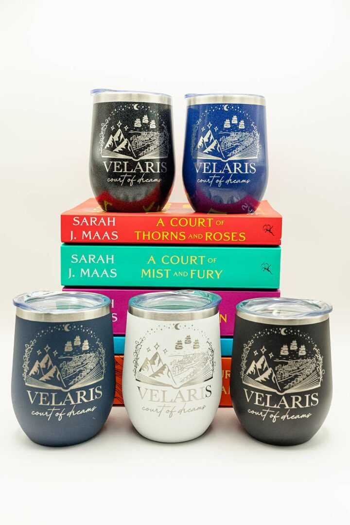 Five ACOTAR Velaris Wine Tumblers surround a vibrant stack of four “A Court of Thorns and Roses” novels, perfect for fans seeking viral book recommendations and contemporary romance fiction gems.