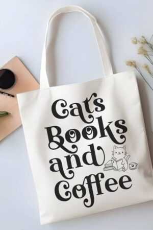The Cats Books and Coffee Canvas Tote Bag features playful black text and a cute cat illustration with books and a coffee cup—perfect for carrying your favorite trending reads. It’s stylish, practical, and ideal for book lovers on the go.