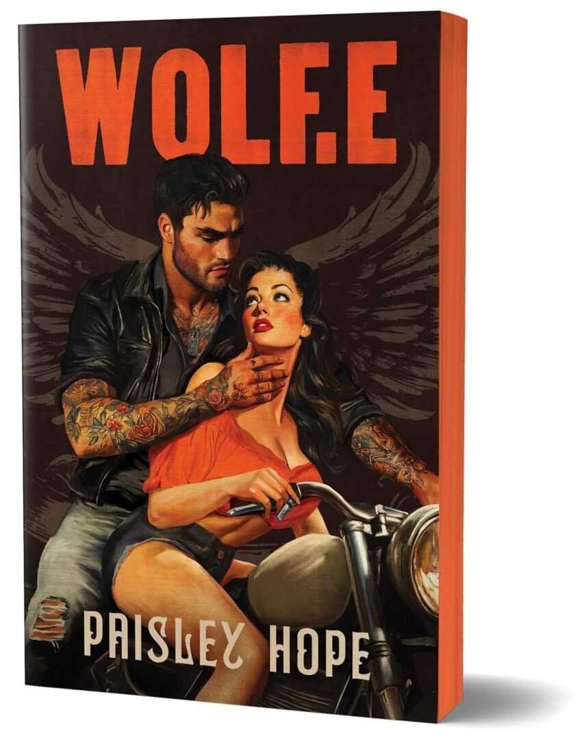 Wolf.E (Deluxe Edition) by Paisley Hope is a paperback from The Soldiers of Bedlam series, featuring striking cover art of a tattooed man gripping a woman's neck as she sits on a motorcycle amid dark, winged designs.