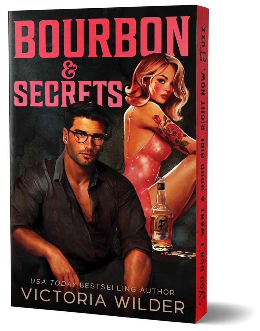 3D book cover of Bourbon & Secrets (Deluxe Edition) by Victoria Wilder (Bourbon Boys, 2 of 3), showing a handsome man in glasses and open shirt beside a tattooed blonde woman with bourbon. Tagline: You don't want a good girl right now.