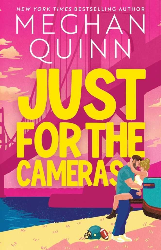 Illustrated book cover for Just for the Cameras (Deluxe Edition) by Meghan Quinn (Bay Area Players, 1 of 2): a couple kisses beside a car, with a football helmet on the ground and a large bridge in the bright background.