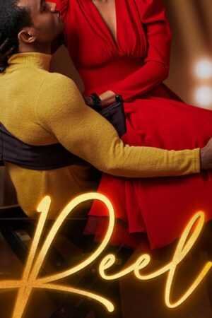 A man in a yellow sweater sits on a director’s chair with a woman in a red dress on his lap, softly lit under stage lights. "Reel - (Hollywood Renaissance) by Kennedy Ryan (Paperback)" glows at the bottom of the scene.